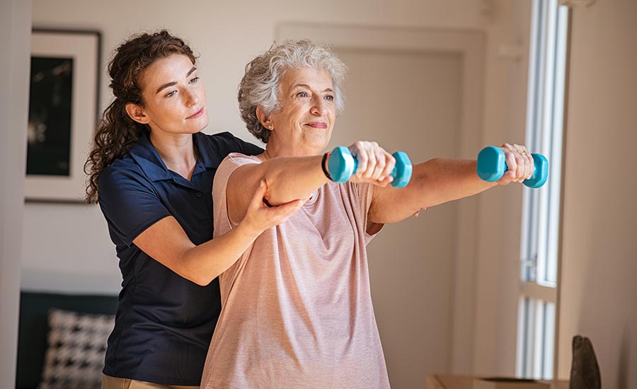 A caregiver helping a senior exercise