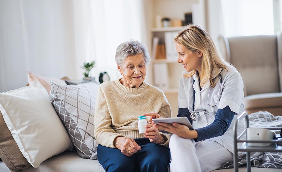 A healthcare professional talking to a senior