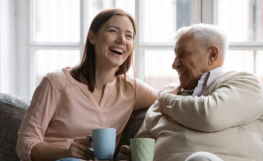 A family caregiver and dementia patient laughing