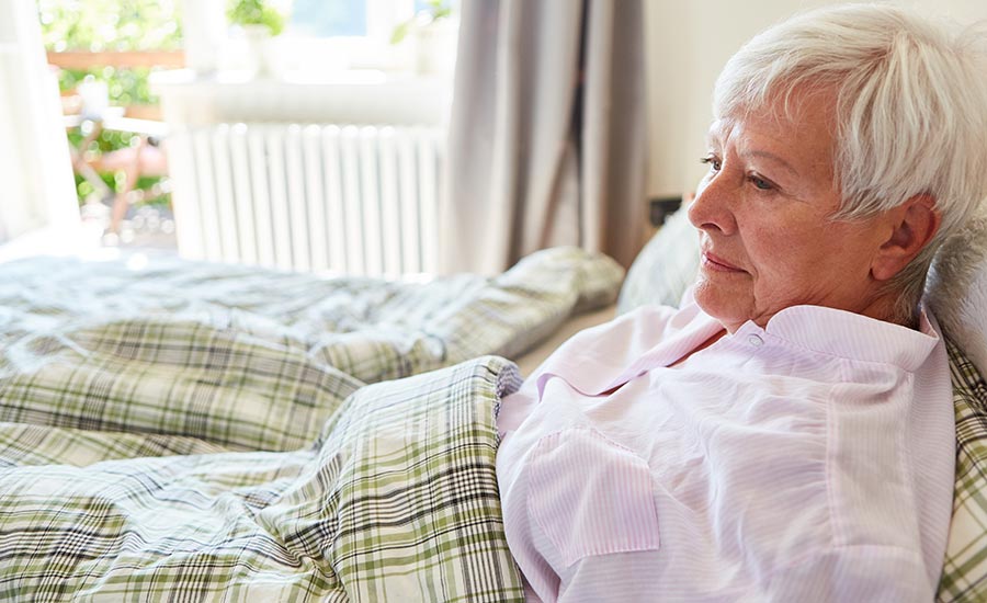 A dementia patient lying on a bed