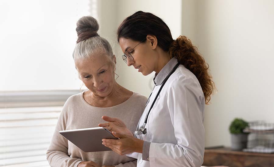 An elderly patient talking to a doctor​