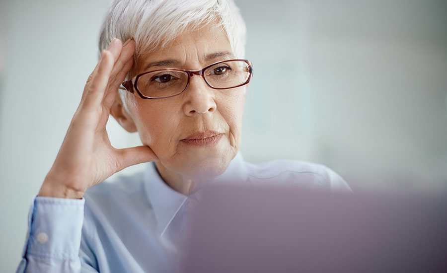 A senior female reading the newspaper​