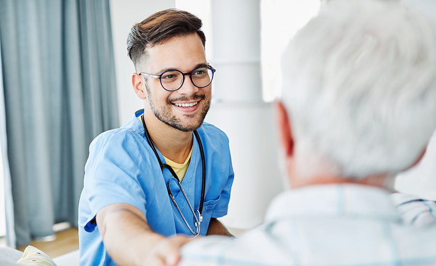 A caregiver reassuring an elderly man