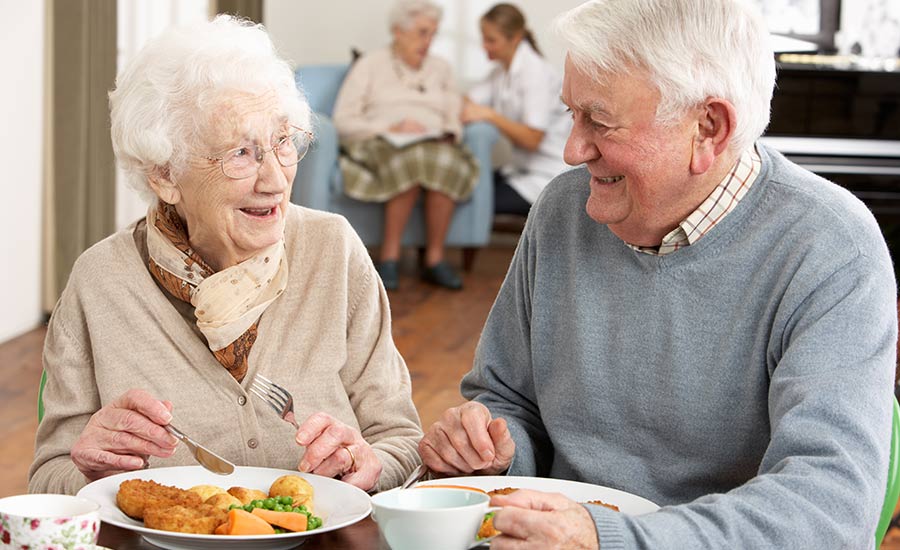 An elderly couple having a meal together