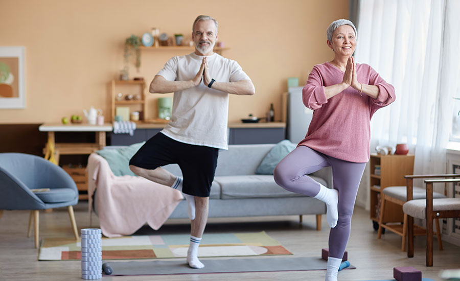 A senior couple exercising in their living room